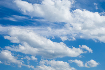 Blue sky and white fluffy clouds. Background. Wallpaper.