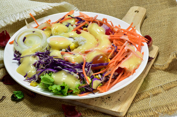 Salad with creamy salad sauce In the White palette laid on a sack.