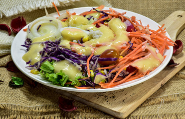 Salad with creamy salad sauce In the White palette laid on a sack.