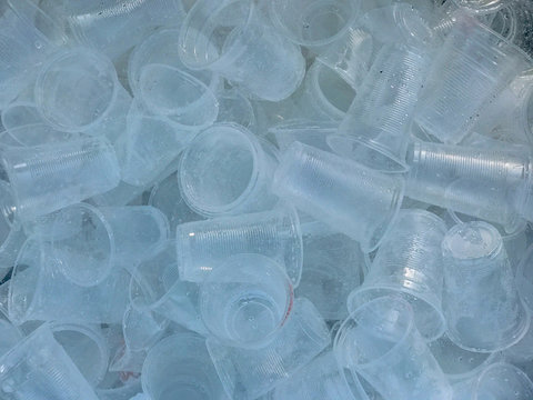 Plastic cup in the trash, Plastic glass used for drinking water, waste plastic bottles, Recyclable garbage of plastic glass,