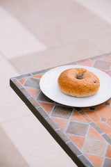 Breakfast Morning Sunny warm weather with donut on white plate on table background. Good mood Horizontal view