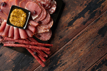 jerky and sausage with french mustard on wood table