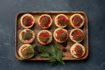 Red caviar in tartalets on a stone table