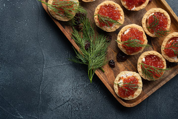 Red caviar in tartalets on a stone table