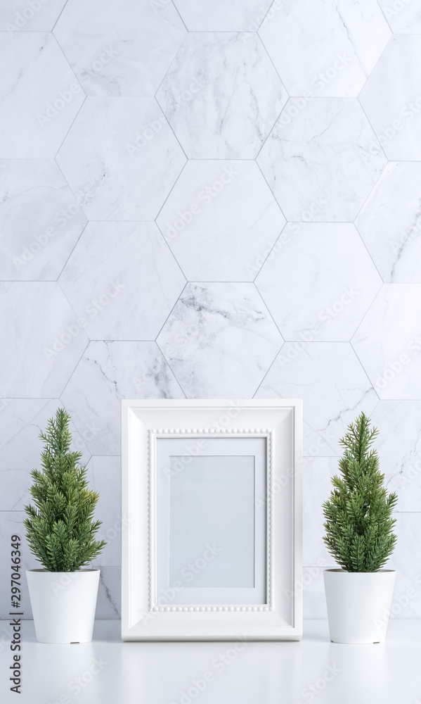 Poster white vintage photo frame with christmas tree,pine cone and decor xmas ball on white table and marbl