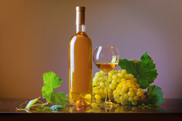 Fototapeta premium Wine. Bottle and glass of white wine with ripe grapes still life. White wine on a light background. Border art design.