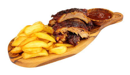 Grilled mini pork ribs and French fries on a wooden serving board isolated on a white background