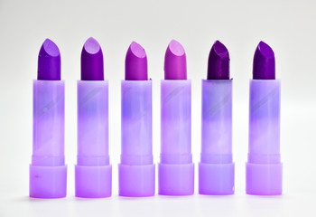 Lipstick shades of purple 6 rods placed on a white background.