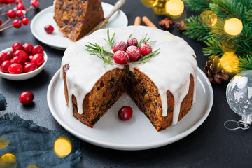 Traditional Christmas fruit cake, pudding with dried fruits, nuts and white glaze.