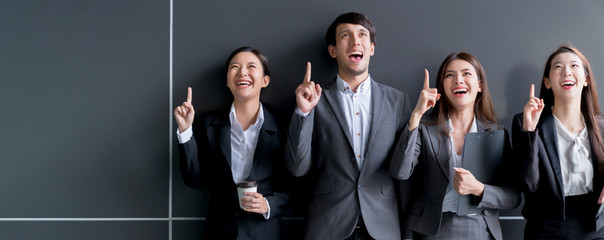 group of smart young asian businessmale and female formal dress teamwork laugh smile standing hand point portrait confident and leadership determination modern office design background