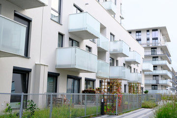 Garden on a courtyard of modern apartment buildings condo with white walls.