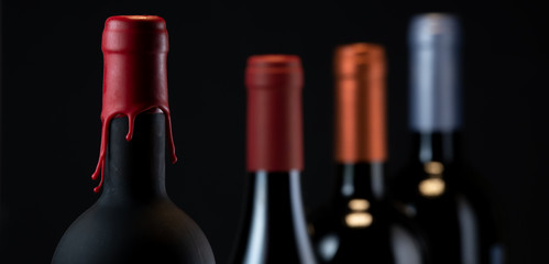 Set of collars red wine bottles isolated on black background