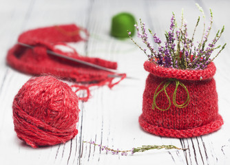 Knitting as a hobby. A large red ball of red thread.