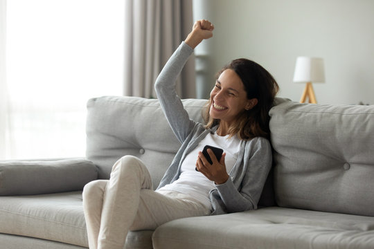 Euphoric Girl Getting Good News Notification Via Mobile Phone.