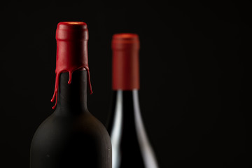 Set of collars red wine bottles isolated on black background