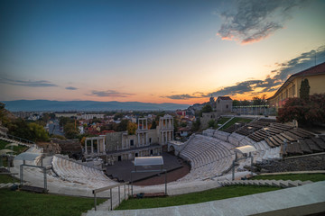 Warm autumn sunset over ancient roman amphitheatre in Plovdiv city - european capital of culture 2019, Bulgaria. The old town is included in UNESCO World Herritage