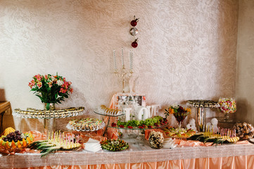 Sweet table decorated in restaurant. Dessert table for a party goodies with sweets, cakes, candy, buffet. Close up. candy bar.