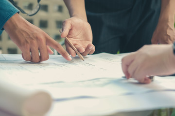 architect engineer working on house blueprint of real estate project. building construction concept.