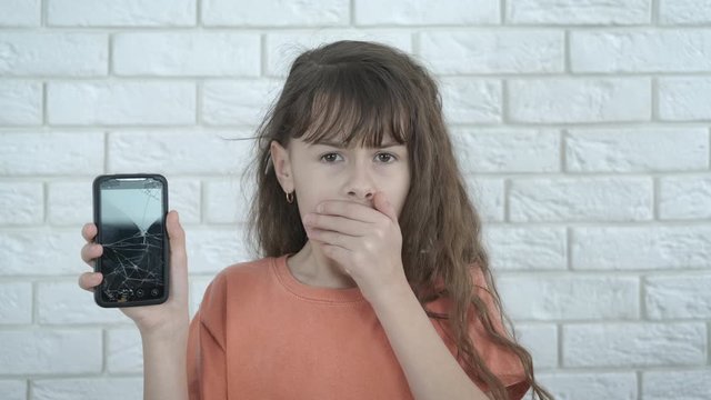 Touch screen with defect. Frightened teenage girl with a broken smartphone.