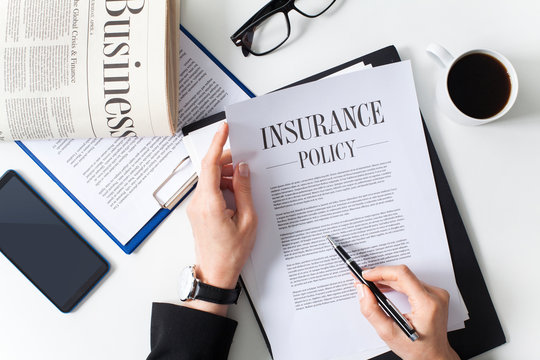 Business woman examining insurance policy