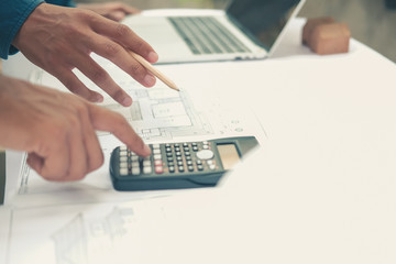 architect engineer working on house blueprint of real estate project. building construction concept.