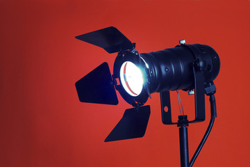 A studio spotlight facing the camera on a bright background
