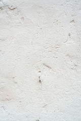 Fine-grained concrete wall in light colors.