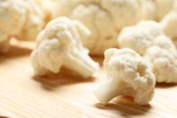 Fresh cauliflower close-up on a brown wooden table