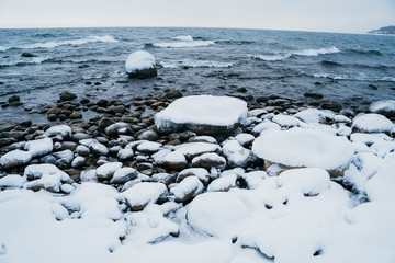 lake's shore in winter with stones