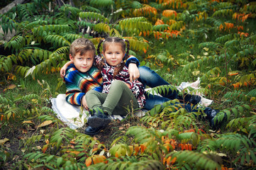 Happy children on vacation in the autumn forest . Brother and sister on autumn walk