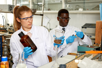 Fototapeta premium Young woman and man scientists working in research laboratory