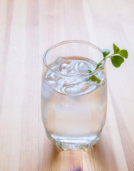 glass of cold water on wooden table