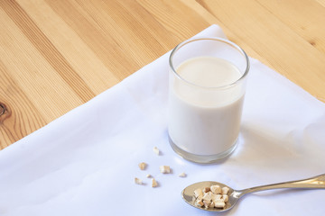 glass of milk on wooden and White cloth