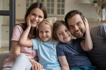 Head shot portrait happy parents with little daughter and son