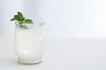 Organic probiotic milk kefir drink or yogurt in glass containers,on the white grey background. Gut...