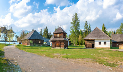 Fototapeta na wymiar Old traditional houses and wooden belfry of village Pribylina in Liptov region (SLOVAKIA) - PANORAMA