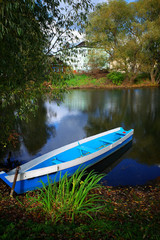 Blue boat at river beach travel background