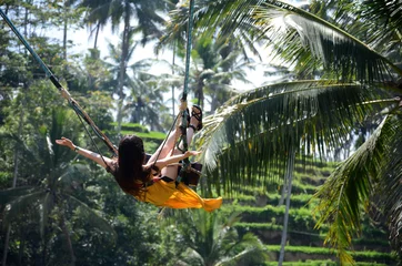 Rolgordijnen Jonge vrouw slingert in het jungle-regenwoud van Bali, Indonesië © tang90246