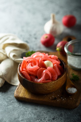 Homemade pickled radish in the wooden bowl