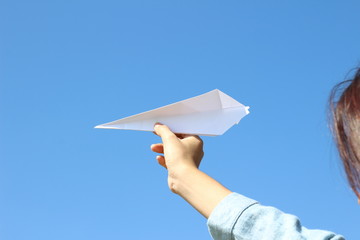 plane paper in hand on sky background