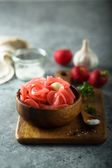 Homemade pickled radish in the wooden bowl