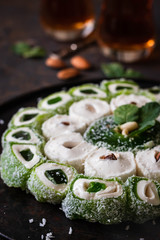 Turkish Delight. Assorted oriental sweets with nuts on a dark background.