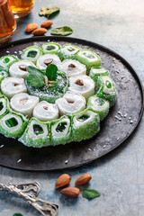 Turkish Delight. Assorted oriental sweets with nuts on a dark background.