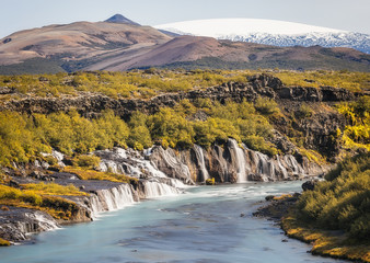 View of Hraunfossar Waterfall and eiriksjokull Glacier on top, Iceland