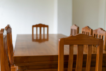 A empty dining wooden table and chairs in the dining room