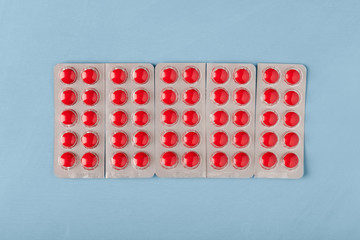Pills in blisters on a blue background