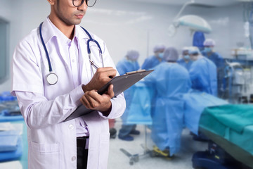 Asia doctor holding application form in Modern Operating Room