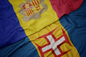 waving colorful flag of madeira and national flag of andorra.