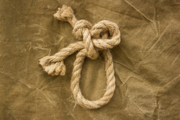 Fototapeta na wymiar knot on khaki background