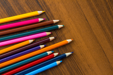 colored pencils on a brown table